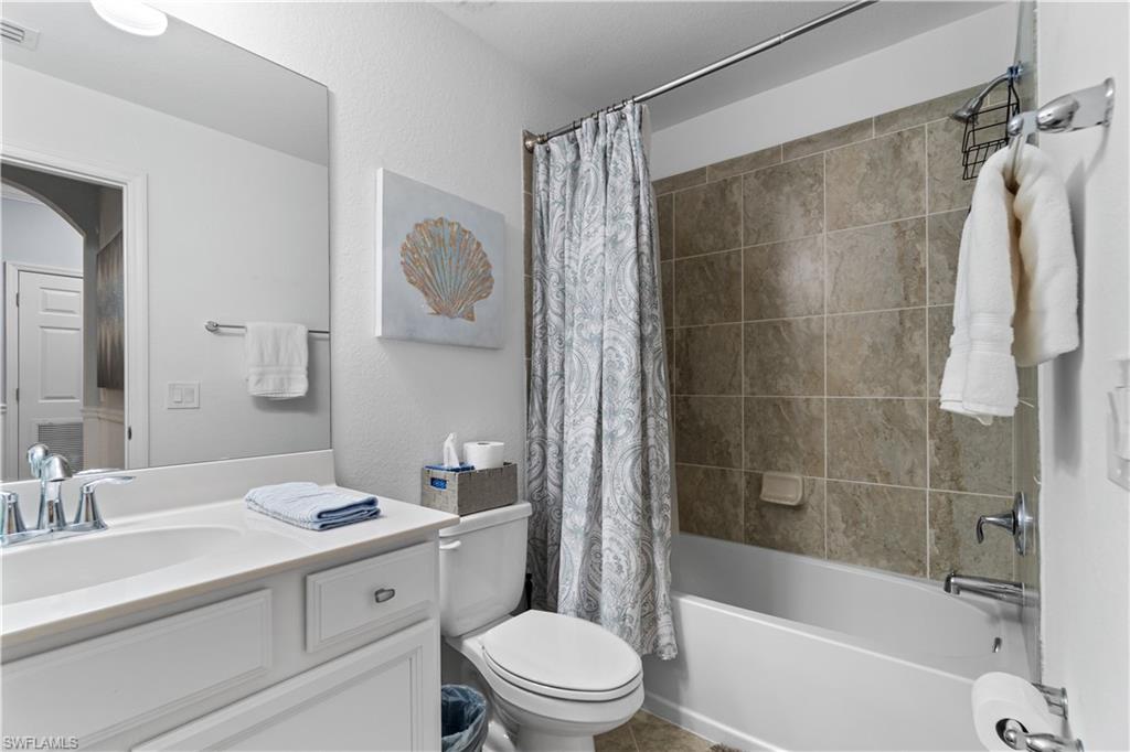 9590 Trevi Court, Unit 5337 Naples, FL 34113 - Photo 10 of 14 a bathroom with a sink a toilet and a bathtub