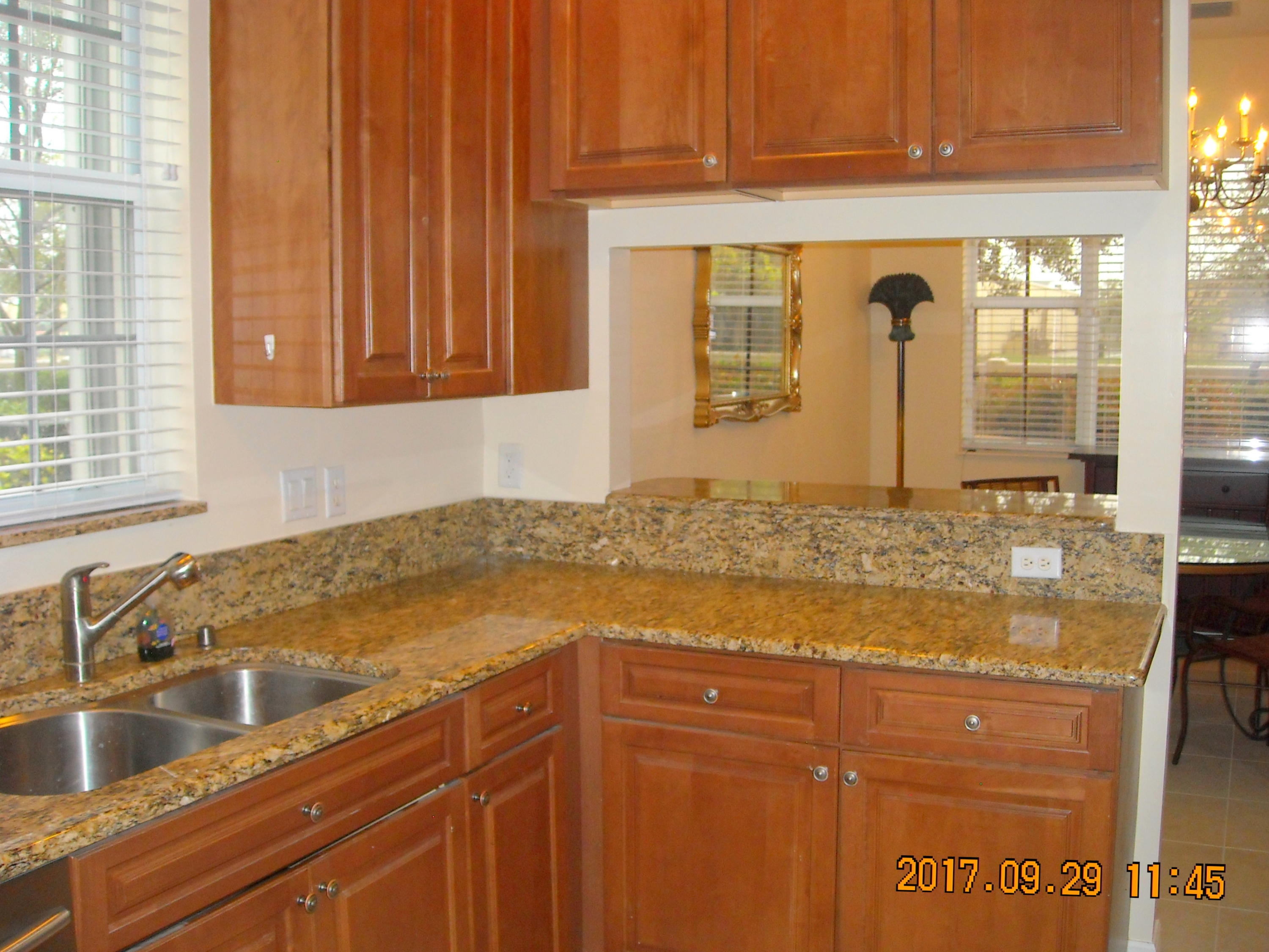 41 Lancaster Road Boynton Beach, FL 33426 - Photo 6 of 32 a kitchen with granite countertop a sink and a window