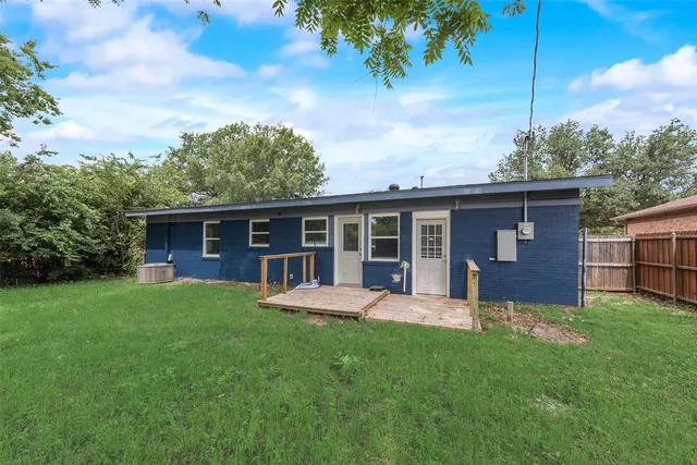 a front view of house with a garden