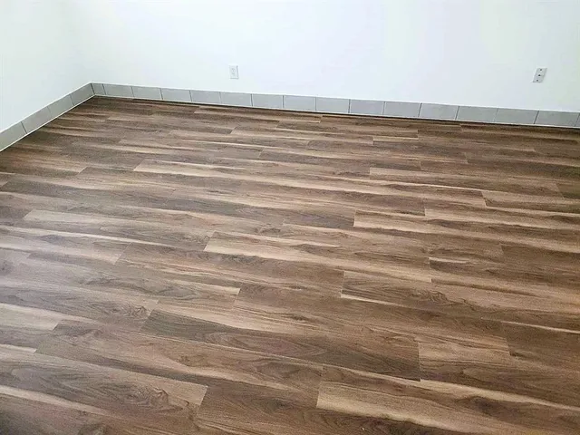 a view of a room with wooden floor