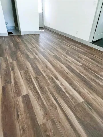 a view of room with wooden floor