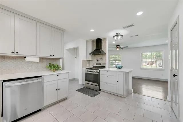 a kitchen with white cabinets and white appliances