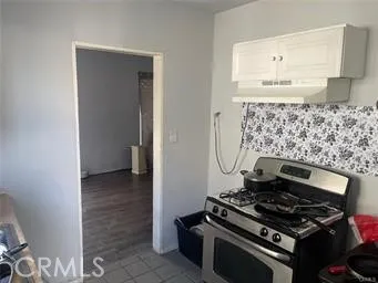 a stove top oven sitting inside of a kitchen