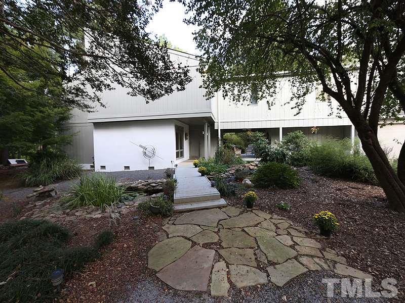 9620 Barton Creek Road Raleigh, NC 27615 - Photo 1 of 23 a front view of a house with garden