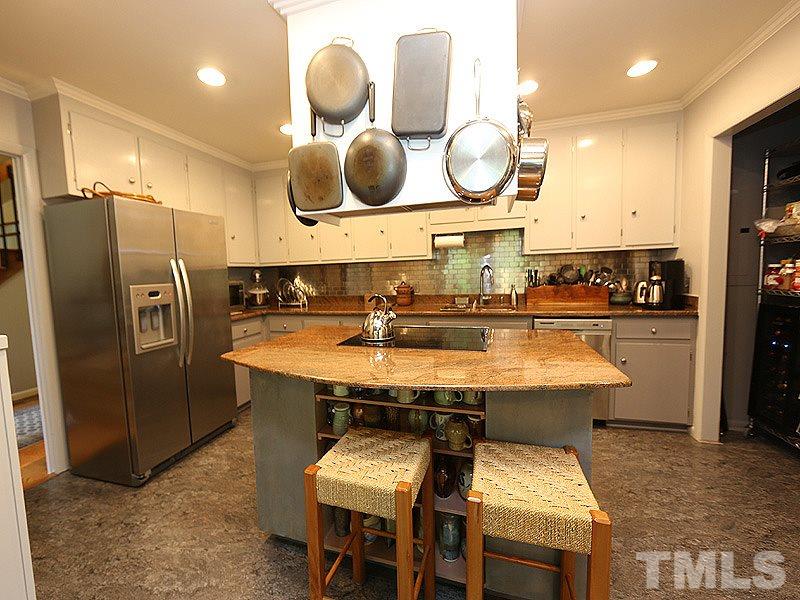 9620 Barton Creek Road Raleigh, NC 27615 - Photo 11 of 23 a kitchen with a sink refrigerator and cabinets