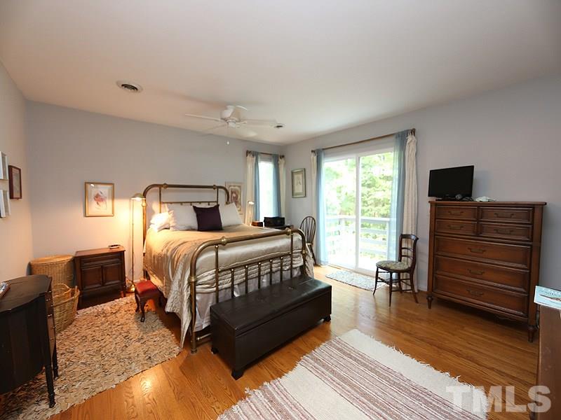 9620 Barton Creek Road Raleigh, NC 27615 - Photo 13 of 23 a bedroom with a bed and wooden floor