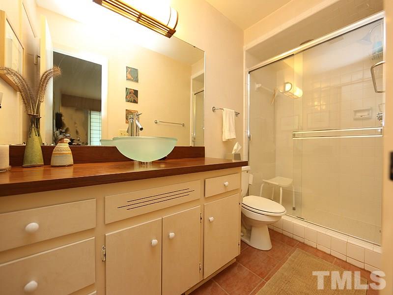 9620 Barton Creek Road Raleigh, NC 27615 - Photo 14 of 23 a bathroom with a double vanity sink toilet and shower