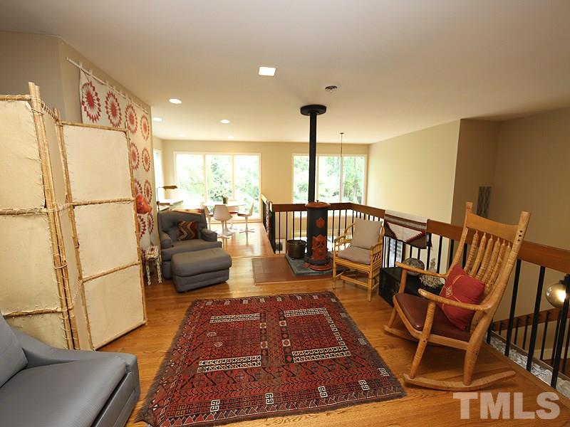 9620 Barton Creek Road Raleigh, NC 27615 - Photo 15 of 23 a very nice looking living room with a rug and a floor to ceiling window