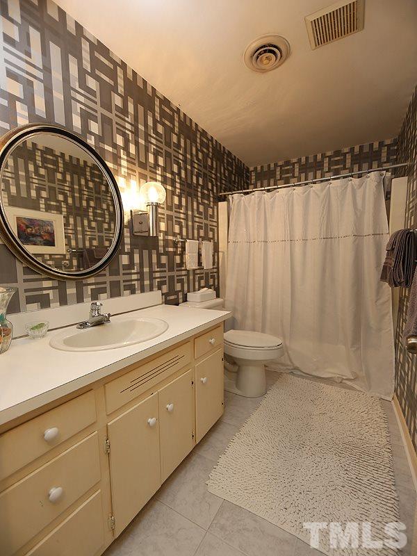 9620 Barton Creek Road Raleigh, NC 27615 - Photo 18 of 23 a bathroom with a sink and a mirror