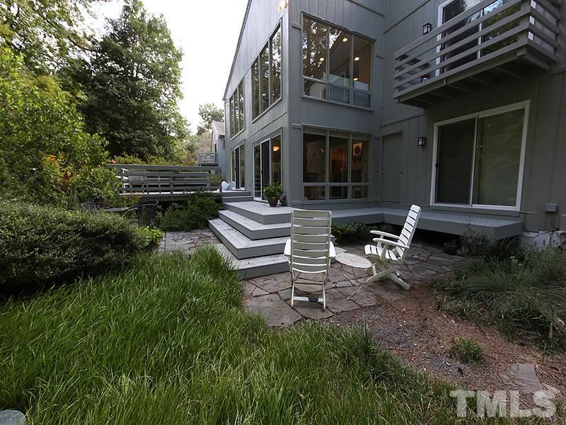 9620 Barton Creek Road Raleigh, NC 27615 - Photo 22 of 23 a view of a house with backyard sitting area and garden
