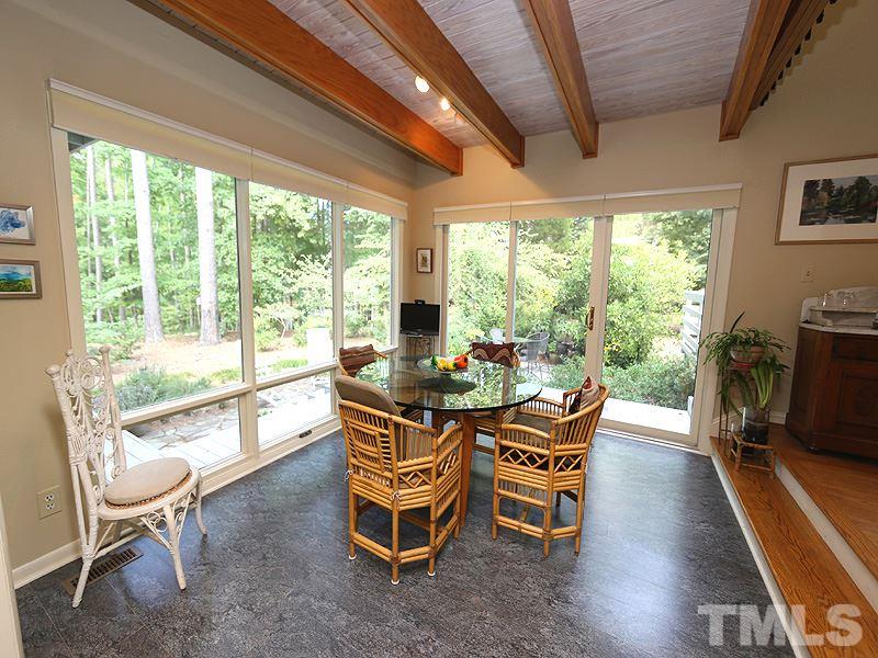 9620 Barton Creek Road Raleigh, NC 27615 - Photo 8 of 23 a dining room with furniture water view and a floor to ceiling window