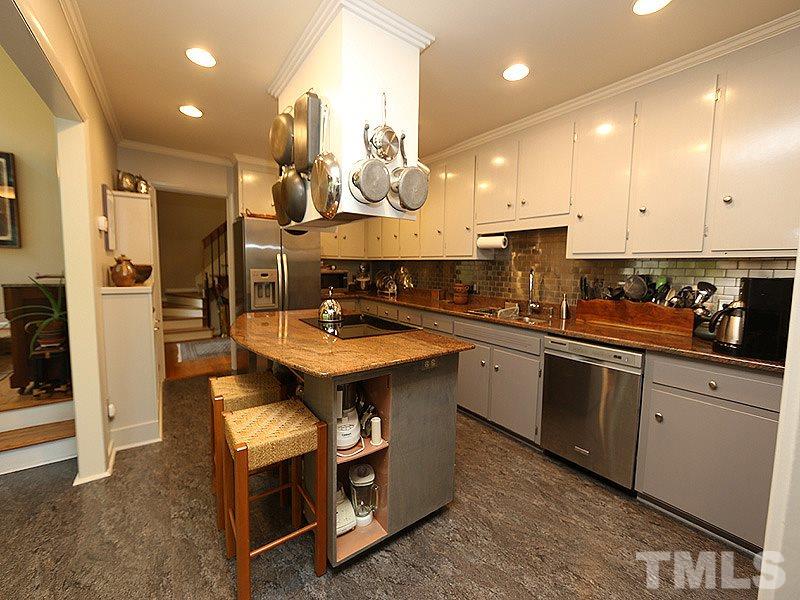 9620 Barton Creek Road Raleigh, NC 27615 - Photo 10 of 23 a kitchen with stainless steel appliances granite countertop a sink a stove and a refrigerator