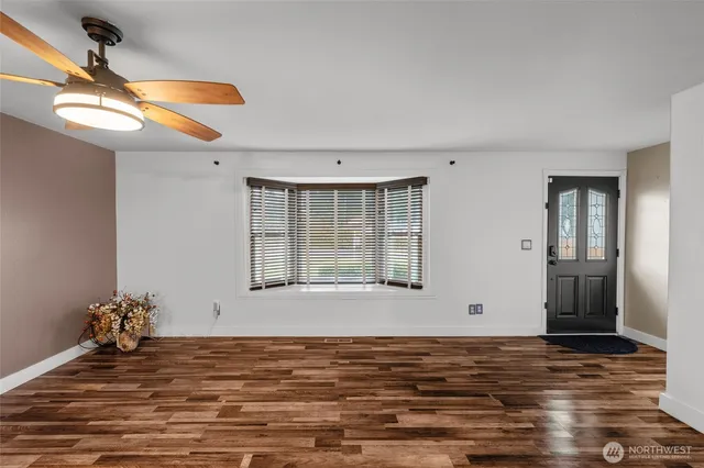 a view of a livingroom with furniture and staircase