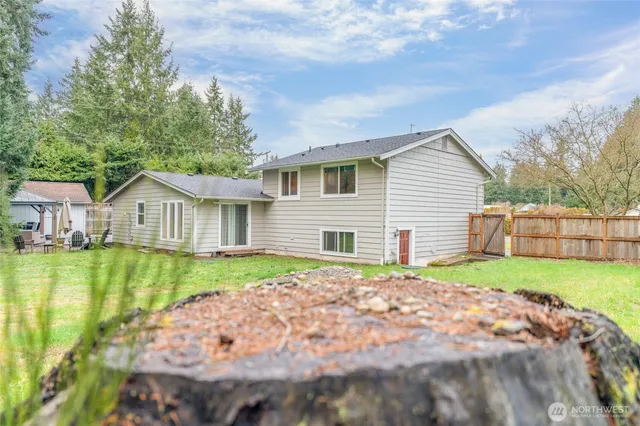 a view of a house with a yard and sitting area