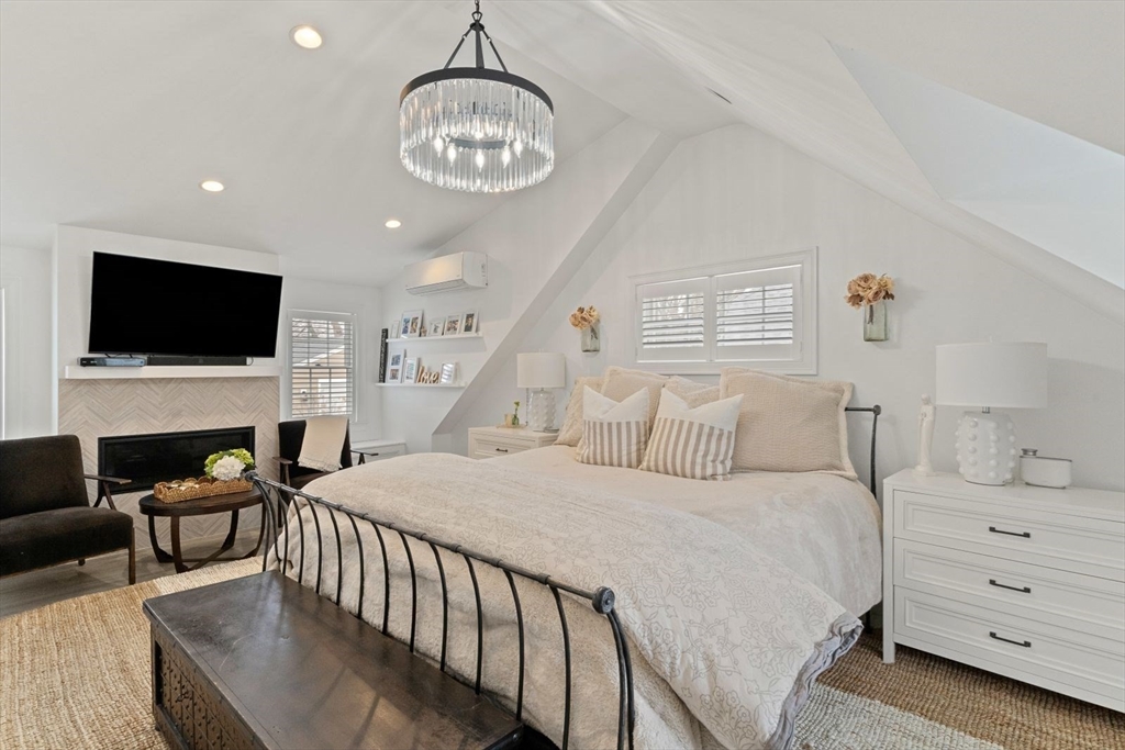 194 Merrymount Road Quincy, MA 02169 - Photo 14 of 32 a bedroom with a bed and a flat screen tv