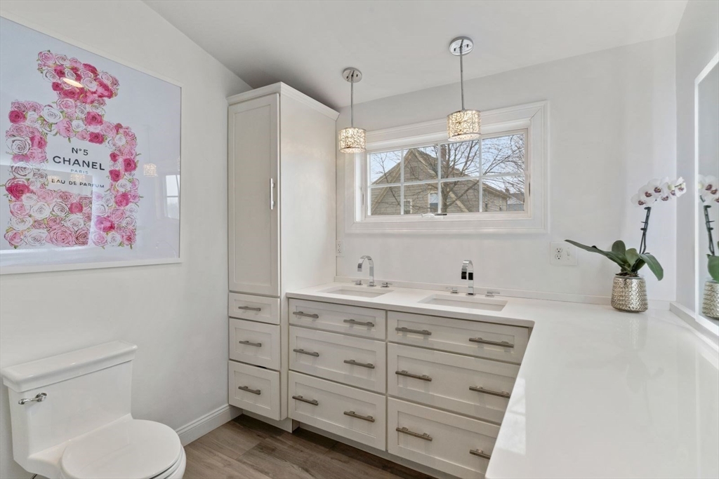 194 Merrymount Road Quincy, MA 02169 - Photo 17 of 32 a bathroom with a granite countertop sink a toilet and a shower