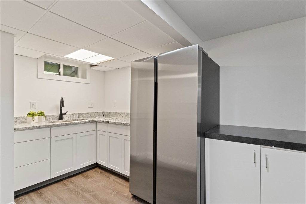 194 Merrymount Road Quincy, MA 02169 - Photo 25 of 32 a kitchen with a sink and refrigerator