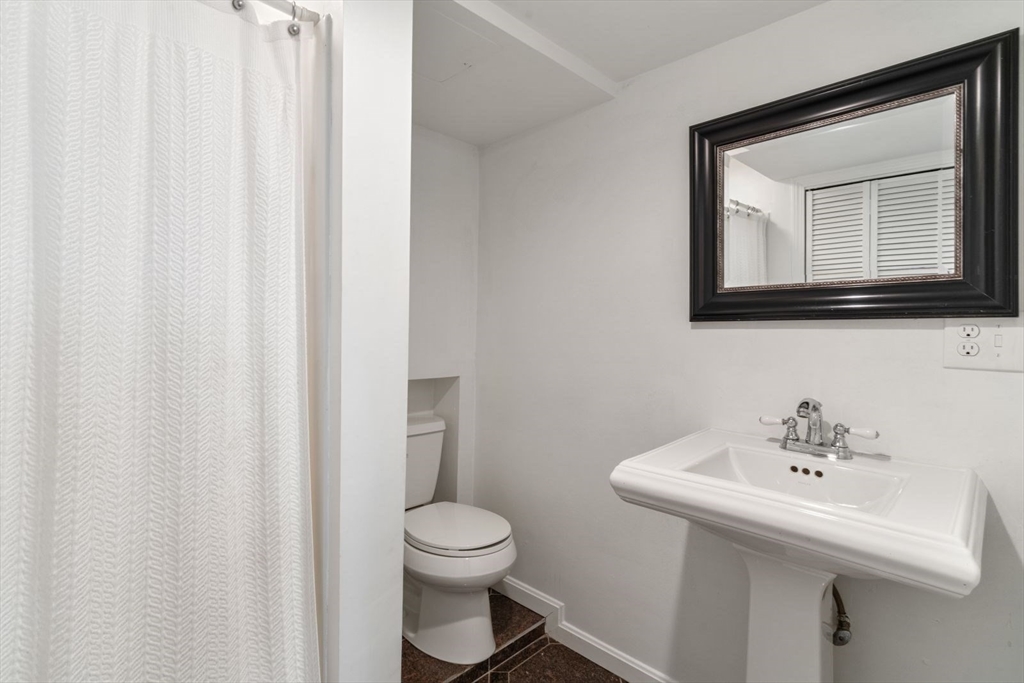 194 Merrymount Road Quincy, MA 02169 - Photo 26 of 32 a bathroom with a toilet sink and mirror