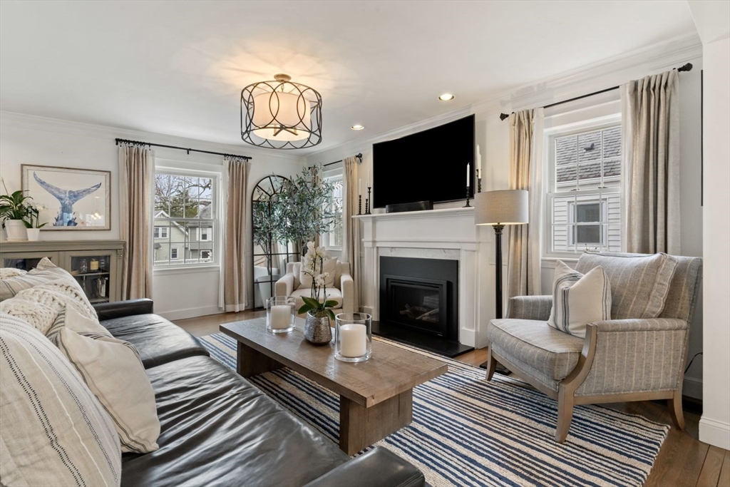 194 Merrymount Road Quincy, MA 02169 - Photo 3 of 32 a living room with furniture a fireplace and a flat screen tv