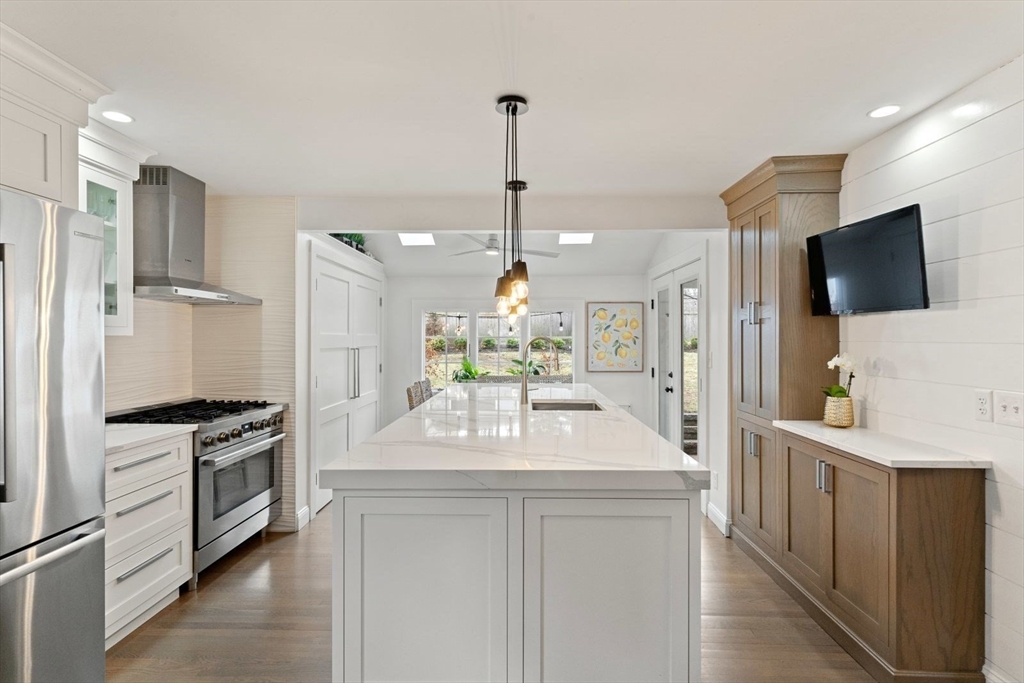 194 Merrymount Road Quincy, MA 02169 - Photo 7 of 32 a kitchen with white cabinets and stainless steel appliances