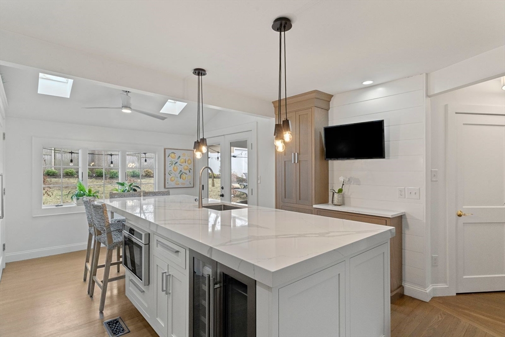 194 Merrymount Road Quincy, MA 02169 - Photo 8 of 32 a kitchen with stainless steel appliances kitchen island a table chairs in it and wooden floor
