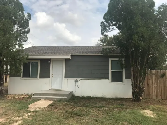 a kitchen with a sink cabinets and a window
