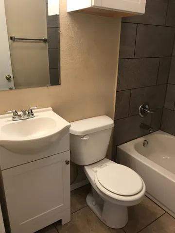 a bathroom with a toilet bathtub and shower