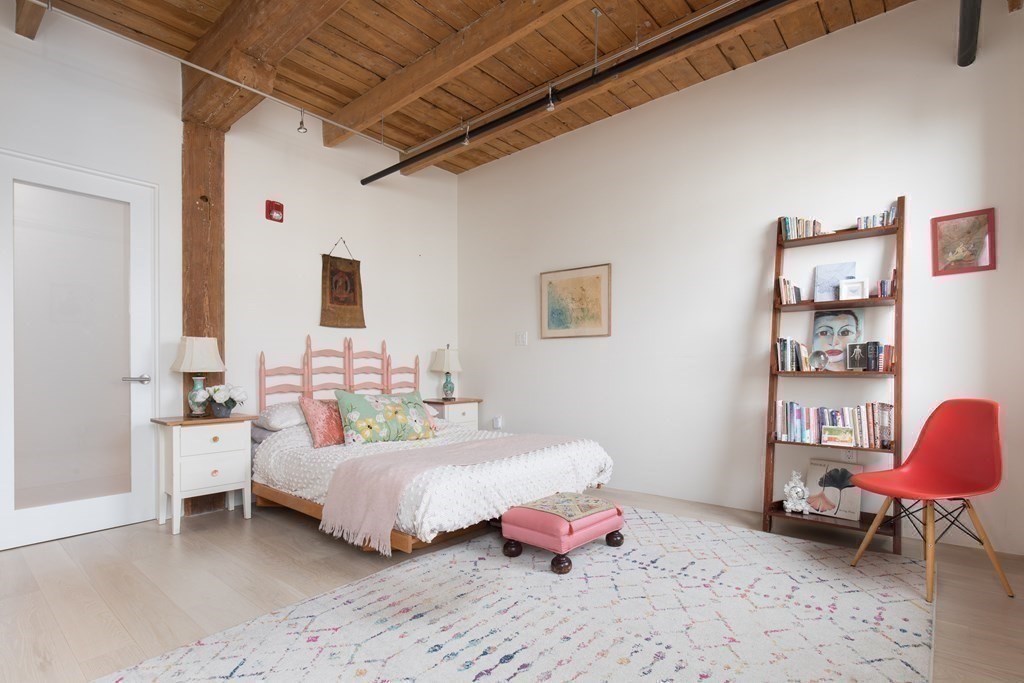 1 Tannery Brook Row, Unit 2A Somerville, MA 02144 - Photo 14 of 18 a bedroom with a bed and a chair