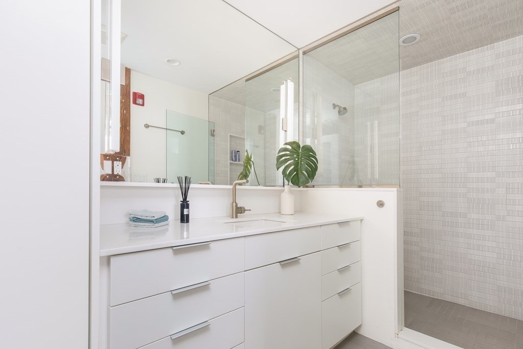 1 Tannery Brook Row, Unit 2A Somerville, MA 02144 - Photo 15 of 18 a bathroom with a sink and a mirror