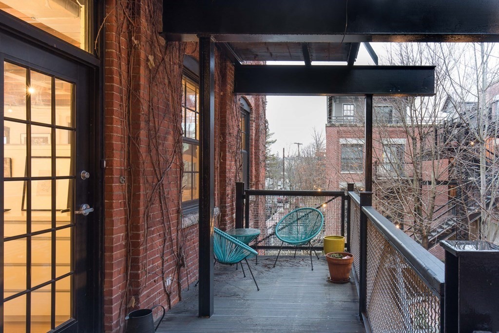 1 Tannery Brook Row, Unit 2A Somerville, MA 02144 - Photo 18 of 18 a living room with furniture and a floor to ceiling window