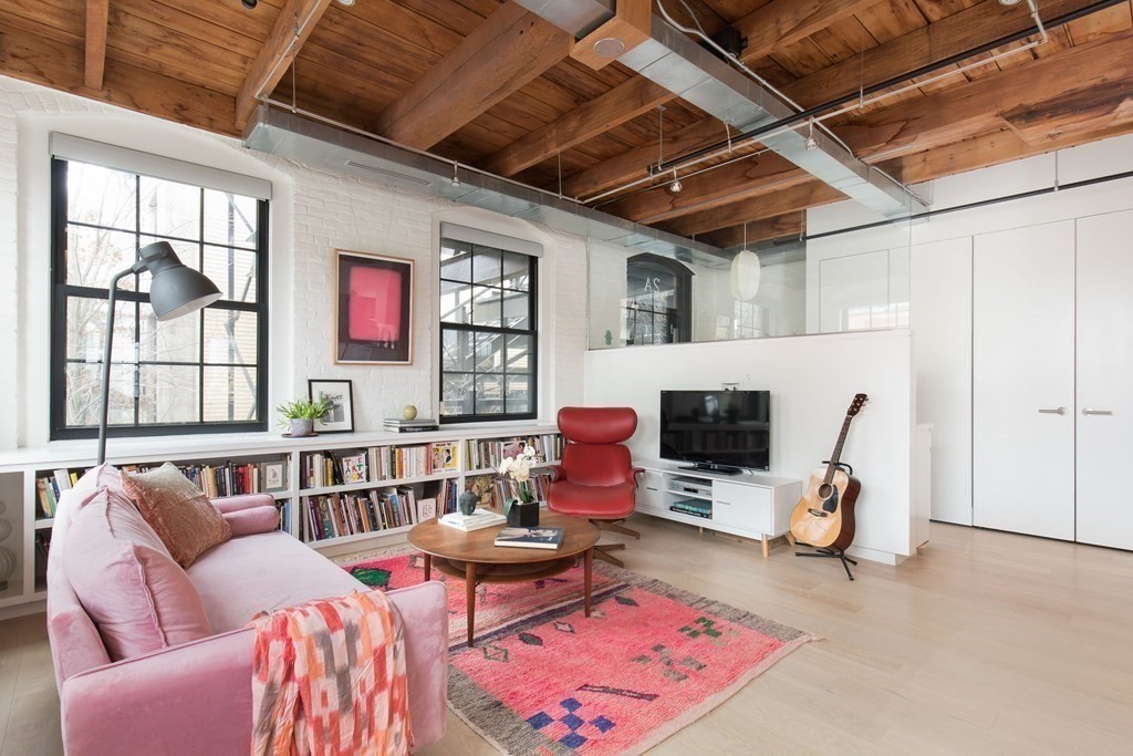 1 Tannery Brook Row, Unit 2A Somerville, MA 02144 - Photo 3 of 18 a living room with furniture a flat screen tv and a fireplace