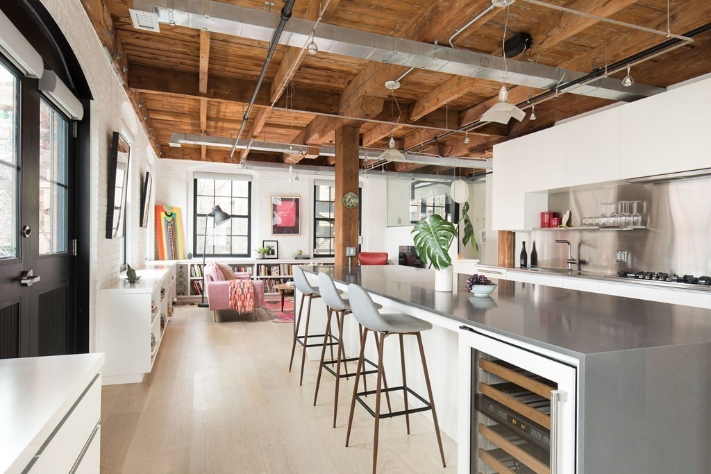 1 Tannery Brook Row, Unit 2A Somerville, MA 02144 - Photo 4 of 18 a kitchen with stainless steel appliances granite countertop lots of counter top space
