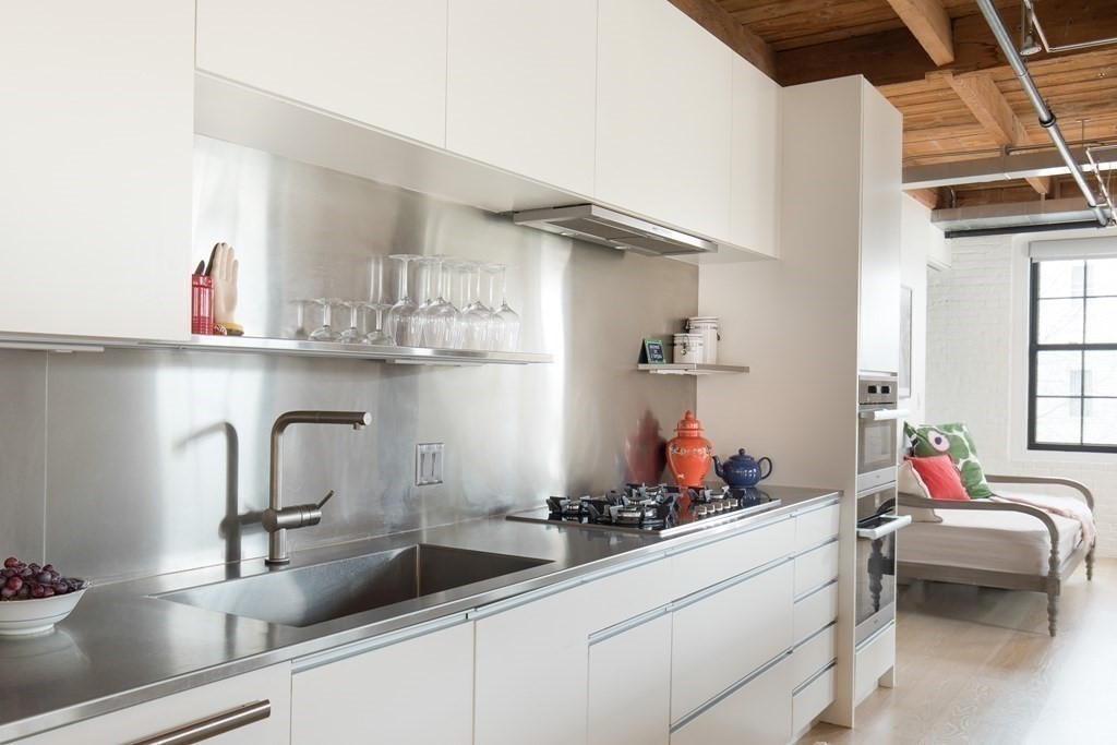 1 Tannery Brook Row, Unit 2A Somerville, MA 02144 - Photo 5 of 18 a kitchen with cabinets a sink and appliances