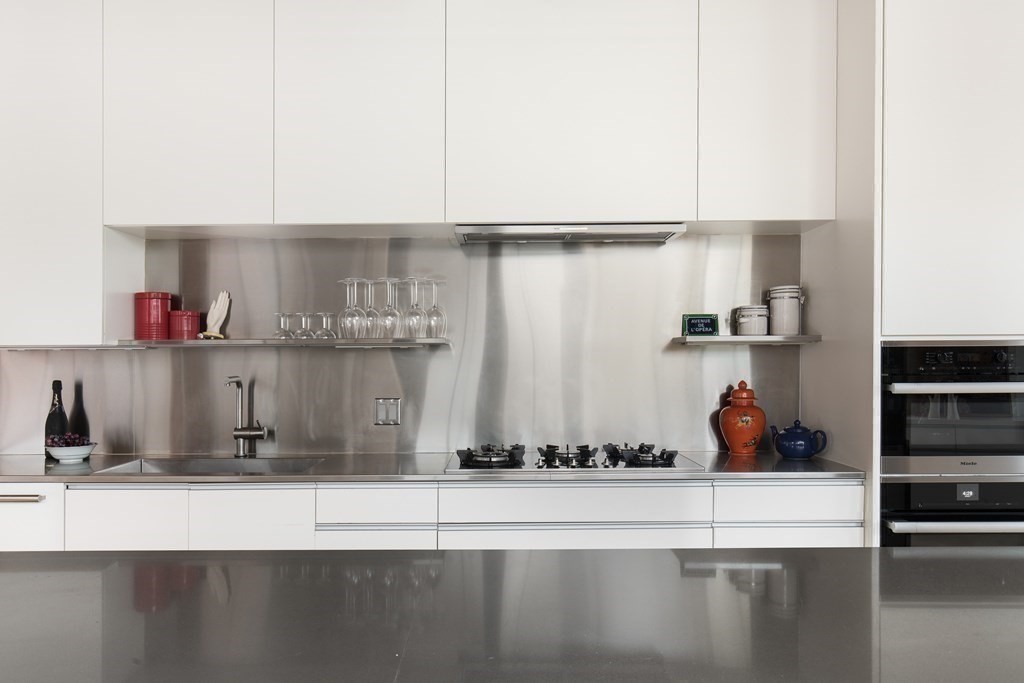 1 Tannery Brook Row, Unit 2A Somerville, MA 02144 - Photo 6 of 18 a kitchen with a refrigerator and cabinets