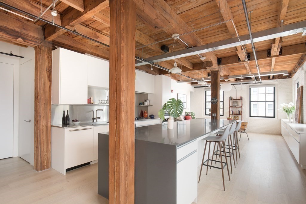 1 Tannery Brook Row, Unit 2A Somerville, MA 02144 - Photo 7 of 18 a view of a dining room with furniture a chandelier and wooden floor