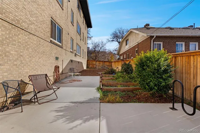 a view of a patio with iron fence
