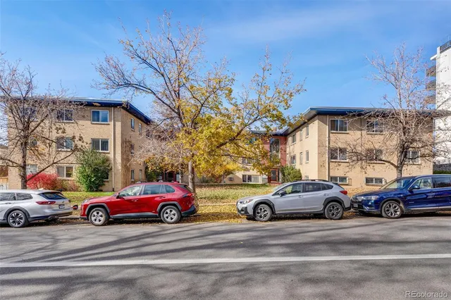 a view of a cars parked on the side of a street