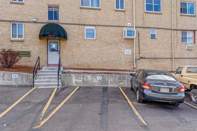 a car parked in front of a brick building