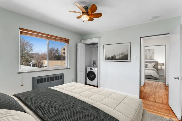 a bedroom with a bed and a painting on the wall