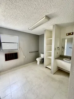 a view of a livingroom with furniture and staircase