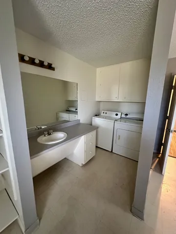 a kitchen with a sink appliances and cabinets