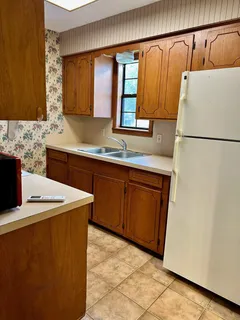 a kitchen with stainless steel appliances a sink and a refrigerator