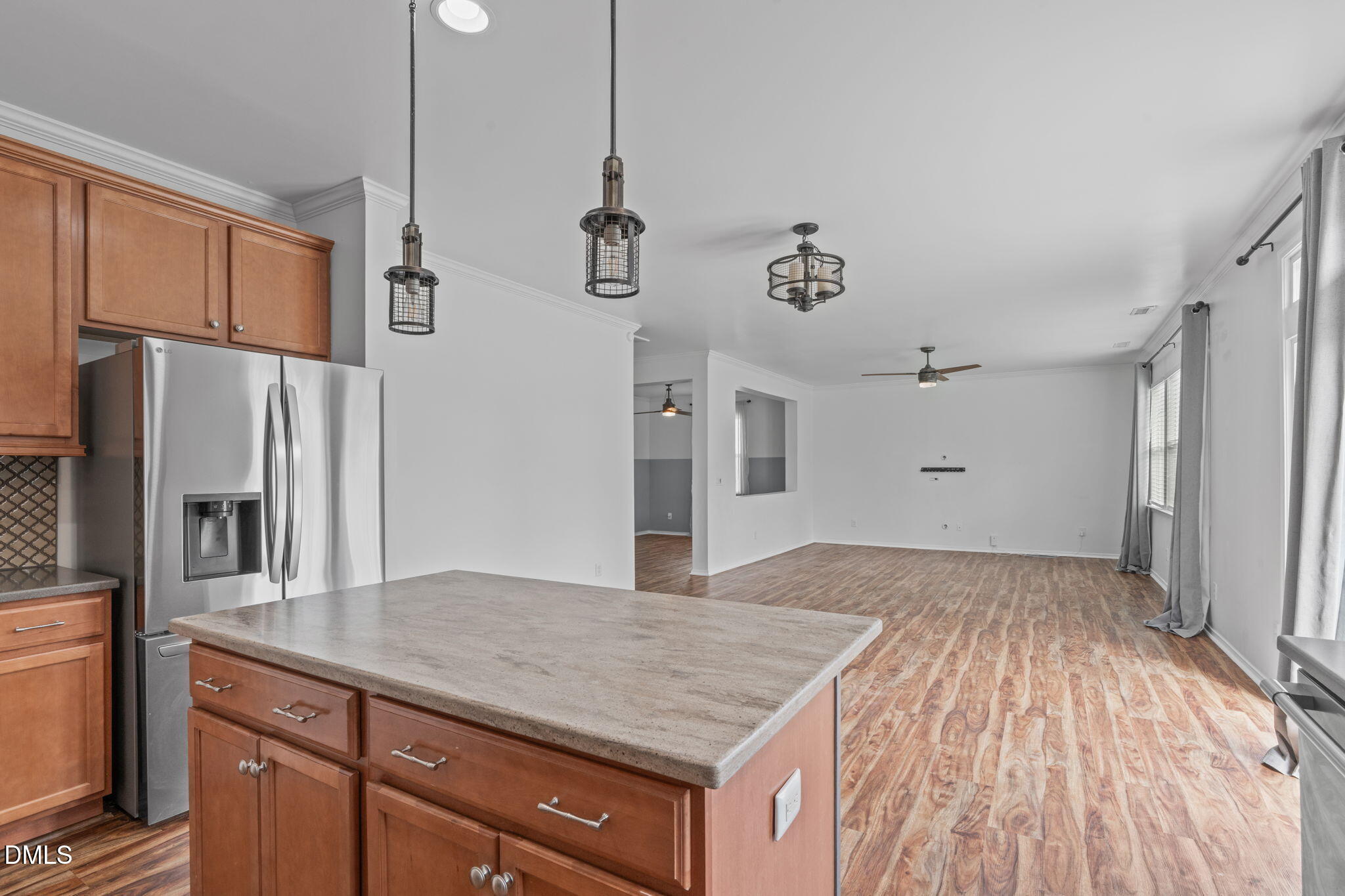 124 Daneborg Road Durham, NC 27703 - Photo 32 of 40 a kitchen with kitchen island white cabinets and stainless steel appliances