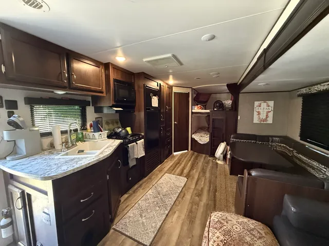 a kitchen with a sink a counter space and stainless steel appliances
