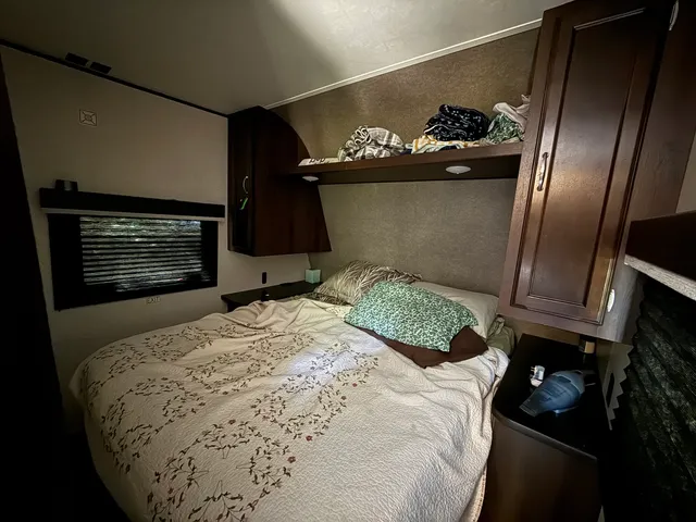 a bedroom with a bed and a television