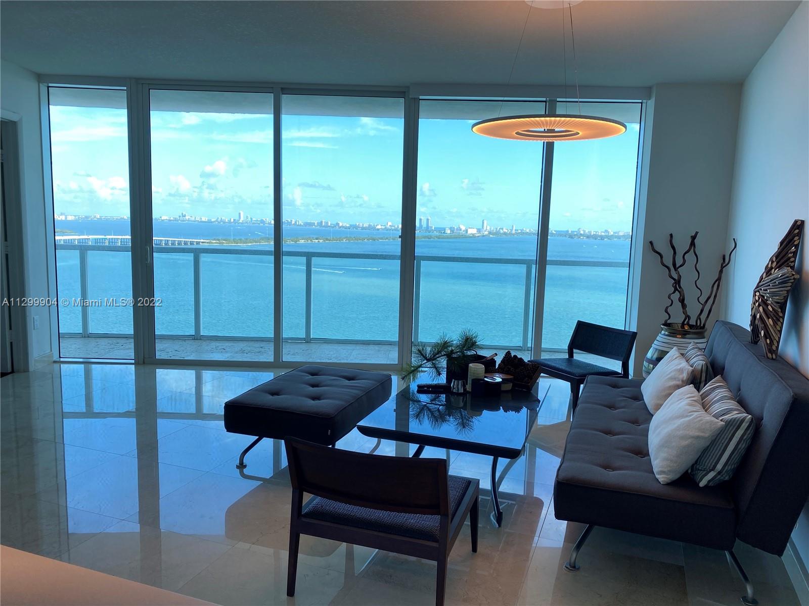 665 Northeast 25th Street, Unit 2104 Miami, FL 33137 - Photo 1 of 38 a view of a dining room with furniture window and outside view
