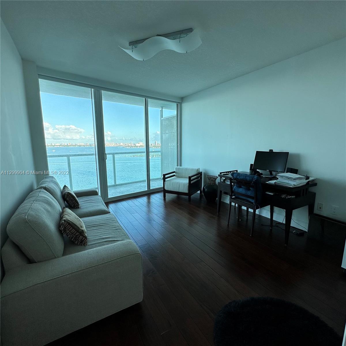 665 Northeast 25th Street, Unit 2104 Miami, FL 33137 - Photo 12 of 38 a living room with furniture and a large window