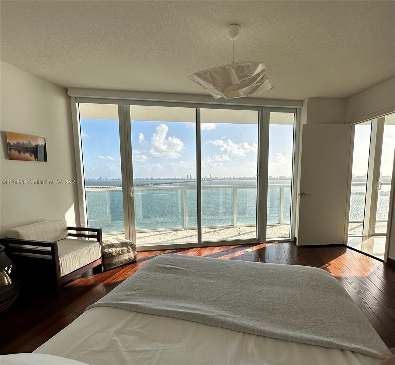 665 Northeast 25th Street, Unit 2104 Miami, FL 33137 - Photo 3 of 38 a living room with a large bed and a large window