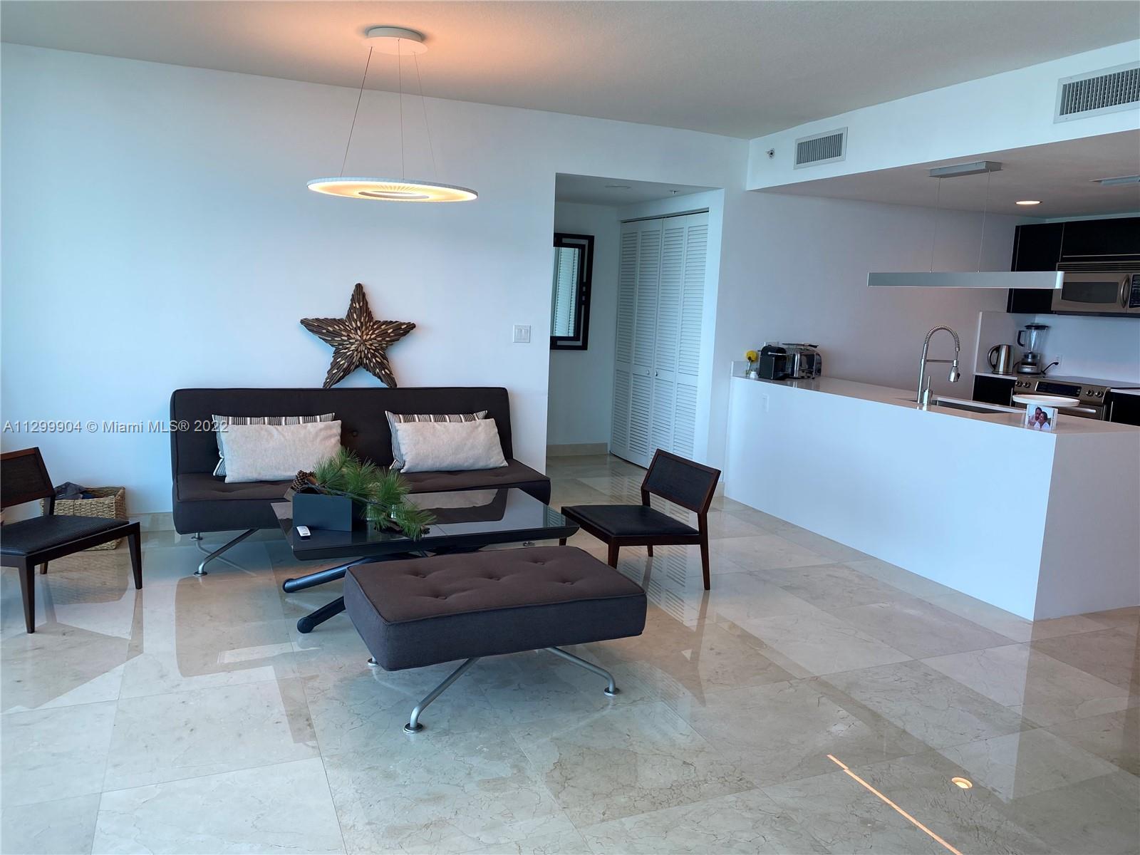665 Northeast 25th Street, Unit 2104 Miami, FL 33137 - Photo 5 of 38 a living room with furniture and a wooden floor