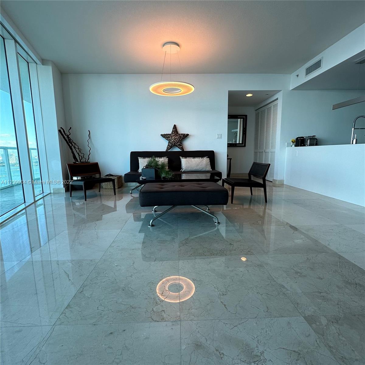 665 Northeast 25th Street, Unit 2104 Miami, FL 33137 - Photo 6 of 38 a living room with furniture and a table